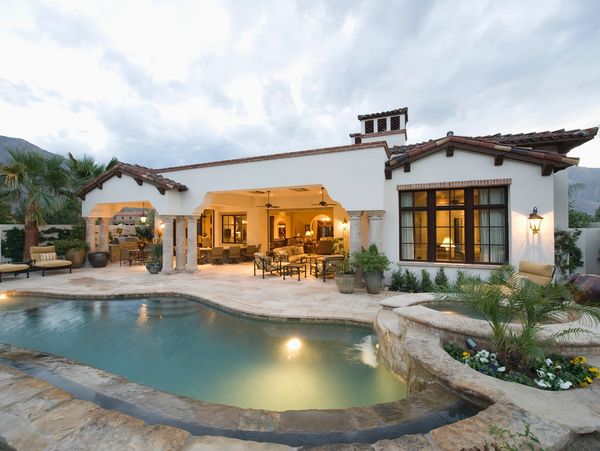 Luxurious Spanish-style villa with pool at dusk